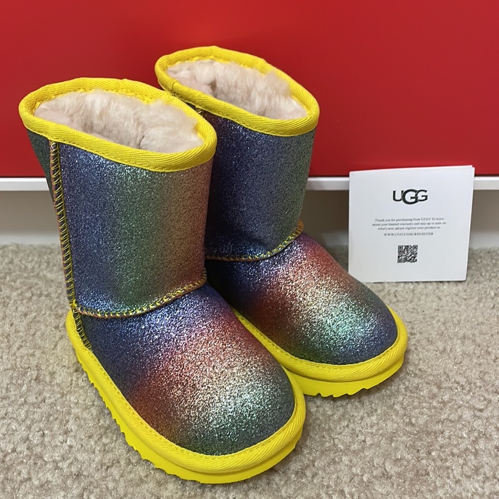 UGG NWT baby girl size 7 classic rainbow sparkle glitter boots with yellow trim.